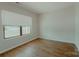 Bedroom with hardwood floors and a large window providing natural light at 945 3Rd Street Sw Pl, Hickory, NC 28602