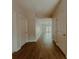Hallway featuring hardwood floors, white trim, and multiple entryways to the living area at 945 3Rd Street Sw Pl, Hickory, NC 28602