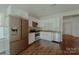 Modern kitchen with white cabinets, stainless steel appliances, granite countertops, and hardwood floors for a clean look at 945 3Rd Street Sw Pl, Hickory, NC 28602