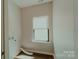 Laundry room with hardwood floors, a window, and hookups for a washer and dryer at 945 3Rd Street Sw Pl, Hickory, NC 28602