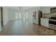 Bright living room with stainless steel appliances, granite counters, and wood-look flooring at 945 3Rd Street Sw Pl, Hickory, NC 28602