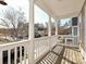 Covered balcony showcasing white columns and railings, offering neighborhood views and outdoor living at 10133 Caldwell Forest Rd, Charlotte, NC 28213