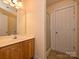 Bathroom featuring a sink vanity, glass door shower, and a white painted door at 10133 Caldwell Forest Rd, Charlotte, NC 28213