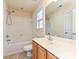 Bathroom featuring a sink, toilet, and shower with tiled walls and a window for natural light at 10133 Caldwell Forest Rd, Charlotte, NC 28213