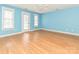 Bright bedroom with hardwood floors, ceiling fan, and two windows, providing ample natural light at 10133 Caldwell Forest Rd, Charlotte, NC 28213