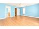 Bright bedroom with a glimpse of the bathroom and hallway, all featuring hardwood floors at 10133 Caldwell Forest Rd, Charlotte, NC 28213