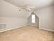 Bonus room featuring carpet floors, attic ceilings, a ceiling fan, and a window letting in natural light at 10133 Caldwell Forest Rd, Charlotte, NC 28213