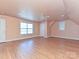 Spacious bonus room with wood flooring, a ceiling fan, and two windows bringing in natural light at 10133 Caldwell Forest Rd, Charlotte, NC 28213