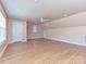 Expansive bonus room with wood floors, a ceiling fan, and multiple windows providing ample natural light at 10133 Caldwell Forest Rd, Charlotte, NC 28213