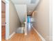 Well-lit hallway with hardwood floors connecting multiple rooms; bright neutral paint at 10133 Caldwell Forest Rd, Charlotte, NC 28213