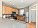 Modern kitchen featuring stainless steel appliances, hardwood floors and granite countertops at 10133 Caldwell Forest Rd, Charlotte, NC 28213