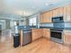 Well-equipped kitchen with stainless steel appliances, stylish cabinetry and hardwood floors at 10133 Caldwell Forest Rd, Charlotte, NC 28213