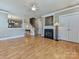 Open-concept living room with hardwood floors, fireplace, and staircase to the upper level at 10133 Caldwell Forest Rd, Charlotte, NC 28213