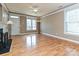 Bright and airy living room with hardwood floors, a fireplace, and large windows at 10133 Caldwell Forest Rd, Charlotte, NC 28213