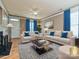 Elegant living room with plush seating, bright blue curtains and ample natural light at 10133 Caldwell Forest Rd, Charlotte, NC 28213