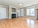 Cozy living room with fireplace, hardwood floors and lots of natural light at 10133 Caldwell Forest Rd, Charlotte, NC 28213