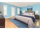 Light-filled bedroom with wood floors, light gray bedding and mountain view art at 10133 Caldwell Forest Rd, Charlotte, NC 28213