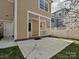Back patio with an entrance door and a white pillar structure, alongside a privacy fence at 10133 Caldwell Forest Rd, Charlotte, NC 28213