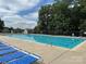 Enjoy lounging poolside at this sparkling community pool with ample seating and beautiful landscaping at 10133 Caldwell Forest Rd, Charlotte, NC 28213