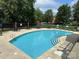 Enjoy community pool featuring clear turquoise water, plenty of seating and lush green landscaping at 10133 Caldwell Forest Rd, Charlotte, NC 28213