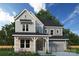 Beautiful two-story home with gray siding, stone accents, and a welcoming front porch at 11209 Shreveport Dr, Huntersville, NC