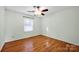 Bedroom includes wood floors, large window, and a ceiling fan at 118 Ashleigh Ct, Fort Mill, SC 29715