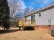 Home with a wooden deck in the backyard with well maintained mulched landscaping at 119 Jack Adams Rd, Kings Mountain, NC 28086