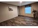 Bedroom view showcasing wood-look flooring, window, and an adjacent doorway at 119 Jack Adams Rd, Kings Mountain, NC 28086