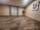 Spacious bedroom with wood-look flooring, a window with blinds, and decorative art at 119 Jack Adams Rd, Kings Mountain, NC 28086