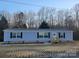 Single-story home featuring light blue siding, black shutters and a wood porch at 119 Jack Adams Rd, Kings Mountain, NC 28086