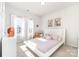 Bright bedroom with white furniture, large windows and unique wall art at 123 Clauser N Rd, Mount Holly, NC 28120