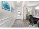 Bright entryway leading to a dining area, featuring wood floors and decorative wall art at 123 Clauser N Rd, Mount Holly, NC 28120