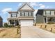 Two-story home with a two-car garage, manicured lawn, and inviting covered front porch at 123 Clauser N Rd, Mount Holly, NC 28120