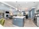 Open kitchen with island and bar seating seamlessly connects to the living area with fireplace at 123 Clauser N Rd, Mount Holly, NC 28120