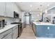 Modern kitchen featuring island with quartz countertop, stainless steel appliances, and hardwood floors at 123 Clauser N Rd, Mount Holly, NC 28120