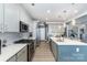 Spacious kitchen featuring an island with quartz countertop, stainless steel appliances and ample cabinetry at 123 Clauser N Rd, Mount Holly, NC 28120