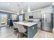 Open concept kitchen with quartz island, stainless steel appliances, and nearby dining area at 123 Clauser N Rd, Mount Holly, NC 28120