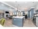 Open kitchen with island connects to living area with fireplace and outside view through large windows at 123 Clauser N Rd, Mount Holly, NC 28120