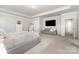 Comfortable main bedroom with a tray ceiling, sofa, and a large television at 123 Clauser N Rd, Mount Holly, NC 28120