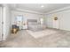 Light-filled main bedroom with tray ceiling, carpet, and neutral tones for a relaxing atmosphere at 123 Clauser N Rd, Mount Holly, NC 28120