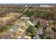 Aerial view of the property showcasing its location in a wooded neighborhood near commercial area at 123 Southhaven Dr, Mooresville, NC 28117