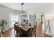 Elegant dining room featuring modern lighting, hardwood floors, and access to other living spaces at 123 Southhaven Dr, Mooresville, NC 28117