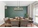 Stylish dining room with a modern chandelier and decorative accent wall at 123 Southhaven Dr, Mooresville, NC 28117
