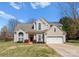 Charming two-story home with a well-manicured lawn and attached two-car garage at 123 Southhaven Dr, Mooresville, NC 28117