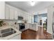 A kitchen with stainless steel appliances, granite countertops, hardwood floors, and cream colored cabinets at 123 Southhaven Dr, Mooresville, NC 28117