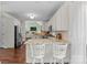 An eat-in kitchen with stainless steel appliances, granite countertops, hardwood floors, and barstool seating at 123 Southhaven Dr, Mooresville, NC 28117