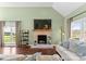 Cozy living room featuring a brick fireplace, hardwood floors, and natural light at 123 Southhaven Dr, Mooresville, NC 28117