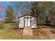 Shed in the backyard with wood doors and a wooden path leading to it at 123 Southhaven Dr, Mooresville, NC 28117