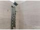 A tiled shower with a unique shower head and wall-mounted controls at 123 Southhaven Dr, Mooresville, NC 28117