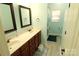 Bathroom featuring double sinks, wood cabinets, vinyl flooring and a shower with a new shower curtain at 1256 Twin Lakes Rd, Rock Hill, SC 29732